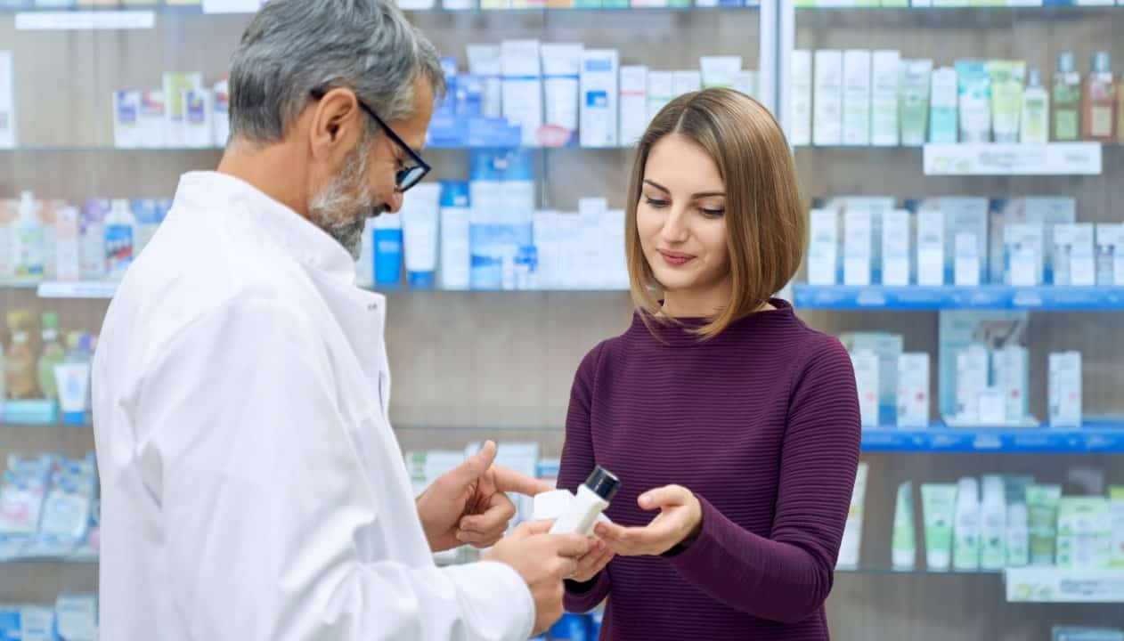pharmacist-helping-woman-medicine-choice